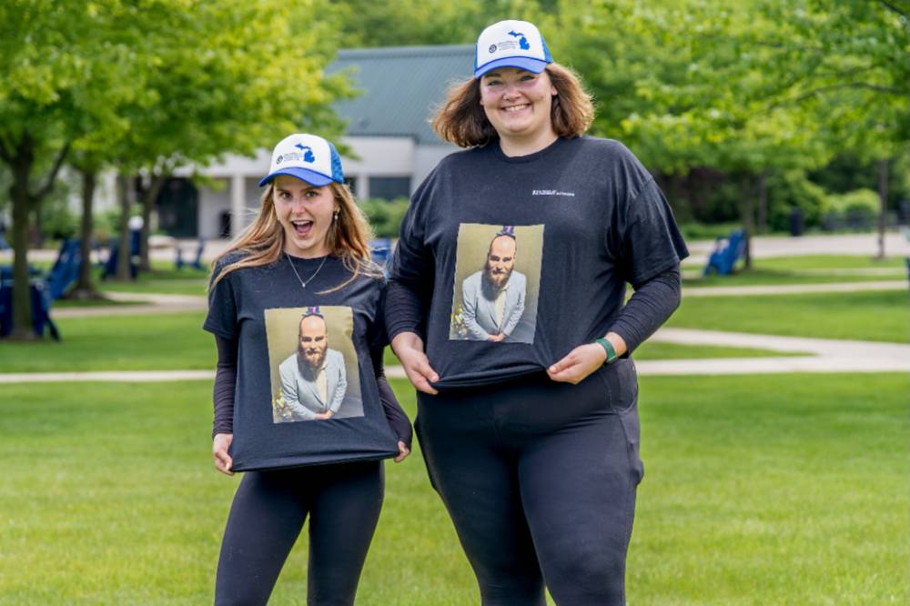 Two players show off their matching shirts and hats